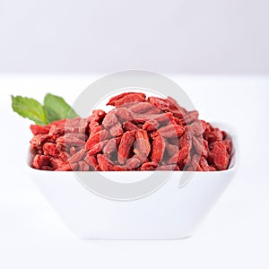 Red dried goji berries in a bowl