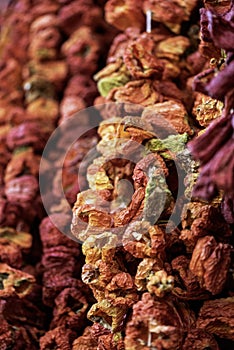 Red dried peppers hanged on a market stall, close up