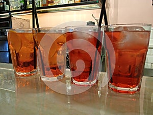 Red drink glass with aperitivo in a local