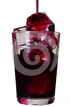 Red drink in a glass with ice cubes