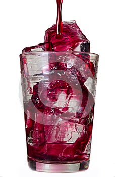 Red drink in a glass with ice cubes