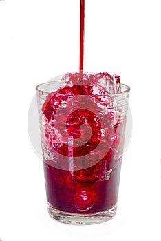 Red drink in a glass with ice cubes