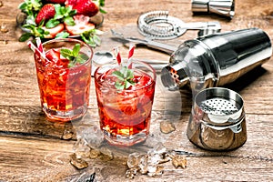 Red drink with ice. Cocktail making bar tools