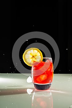 Red drink with lemon