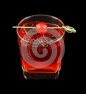 Red drink with a maraschino cherry isolated on black