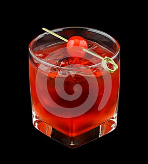 Red drink with a maraschino cherry isolated on black