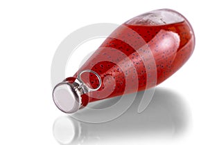 red drinks with basil seeds or falooda seeds or tukmaria in bottles on white background