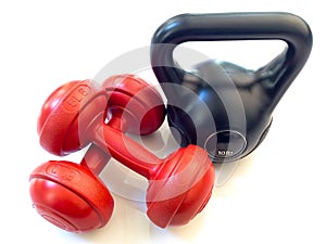 Red dumbbell and black kettlebell