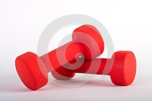 Red dumbbell for fitness on white background