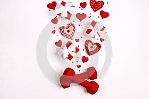 Red dumbbell with hearts and gift boxes on white background