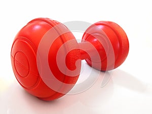 Red dumbbell on white background