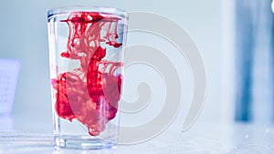 Red Dye in crystal clear water or refreshing drink photo