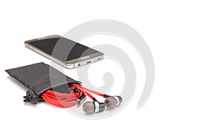 Red earphone and black bag isolated on white background