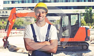 Red earthmover with strong latin american construction worker