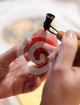 Red Easter egg in the master's hands