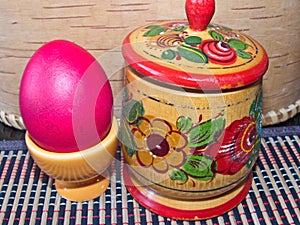 Red Easter egg and a salt in wood a salt shaker. Colorful Easter eggs - part of the passover meal. Easter