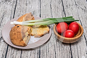 Red Easter Eggs in a Bowl with spring onion.
