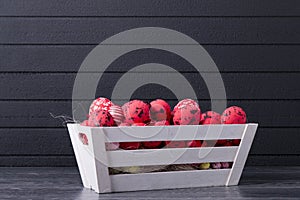 Red Easter eggs in a wooden container