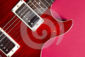 Red electric guitar close-up. Guitar in the style of Les Paul macro.