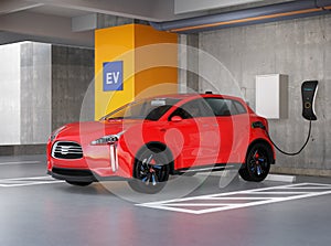 Red electric SUV recharging in parking garage photo