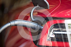 Red Electric Vehicle Plugged In 2