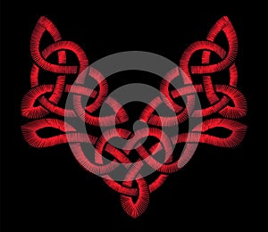 Red embroidery on a black background. Celtic patterns