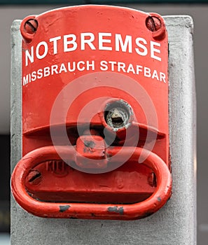 Red emergency brake to stop a large rolling staircase, with German inscription
