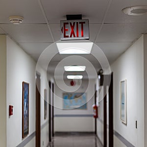 red emergency exit sign in the dark room. illuminated office exit sign