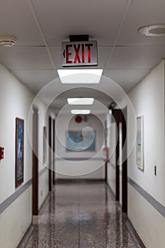 red emergency exit sign in the dark room. illuminated office exit sign