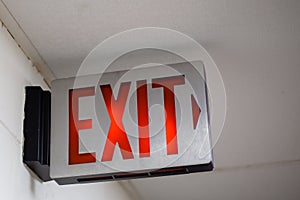 red emergency exit sign in the dark room. illuminated office exit sign