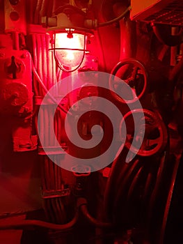 Red emergency lighting on a military submarine