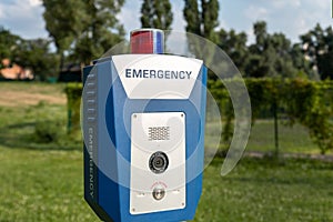 Red emergency police SOS call button alarm box with light bar, cctv camera and speaker device for urgent comunication on