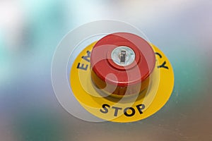 Red emergency stop button on machine for safety