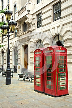 Red english phone booths in a street