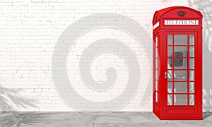 Red english telephone booth on brick wall background