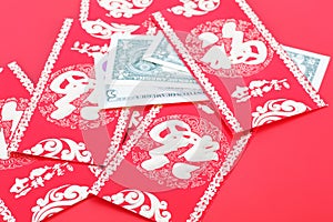 Red envelope and dollar bills on red background.The Chinese characters in the picture mean `happiness`