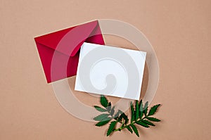 Red envelope with empty white card for text on beige background
