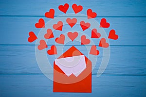 Red envelope with love letter above blue background with many hearts around