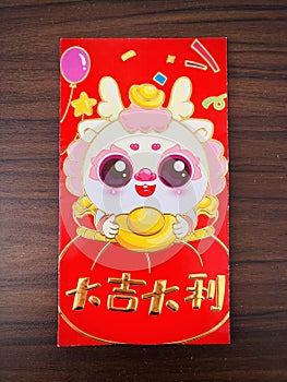 A Red envelopes. good luck in Chinese with cartoon Dragon on wooden background.