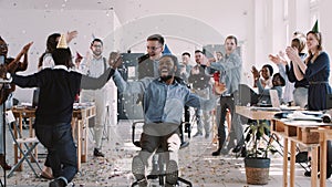 RED EPIC-W Happy young black businessman celebrating birthday at office workplace party with confetti slow motion.