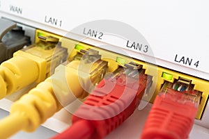 Red ethernet cables are connected to blue internet switch. Symbol of individuality