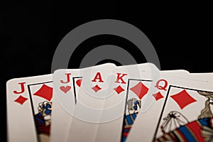 Red euchre diamond hand on black background