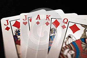 Red euchre diamond hand on black background