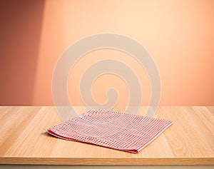 Red fabric,cloth on wood table top on color wall background