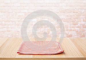 Red fabric,cloth on wood table top on wall background
