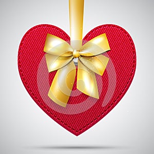 Red fabric heart with golden ribbon