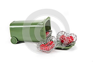 Red fabric heart in knitted wire cage on white background