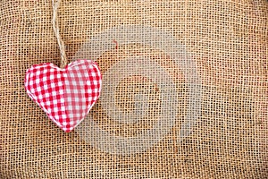Red fabric heart, rustic canvas background