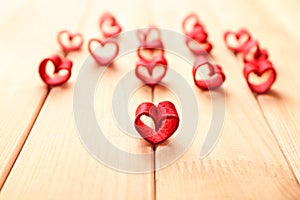 Red fabric hearts on wooden background