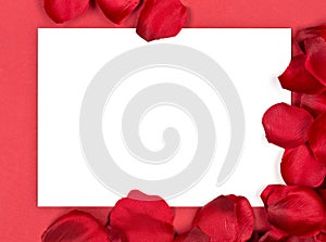 Red fabric rose petals corner with white card over red background top view from above - marriage, love, wedding or valentine`s da